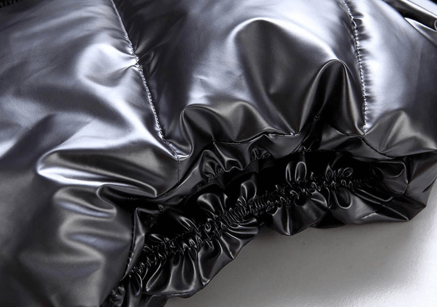 Close-up of shiny black polyester and cotton blend fabric on women's hooded vest, showcasing durable stitching and smooth texture.